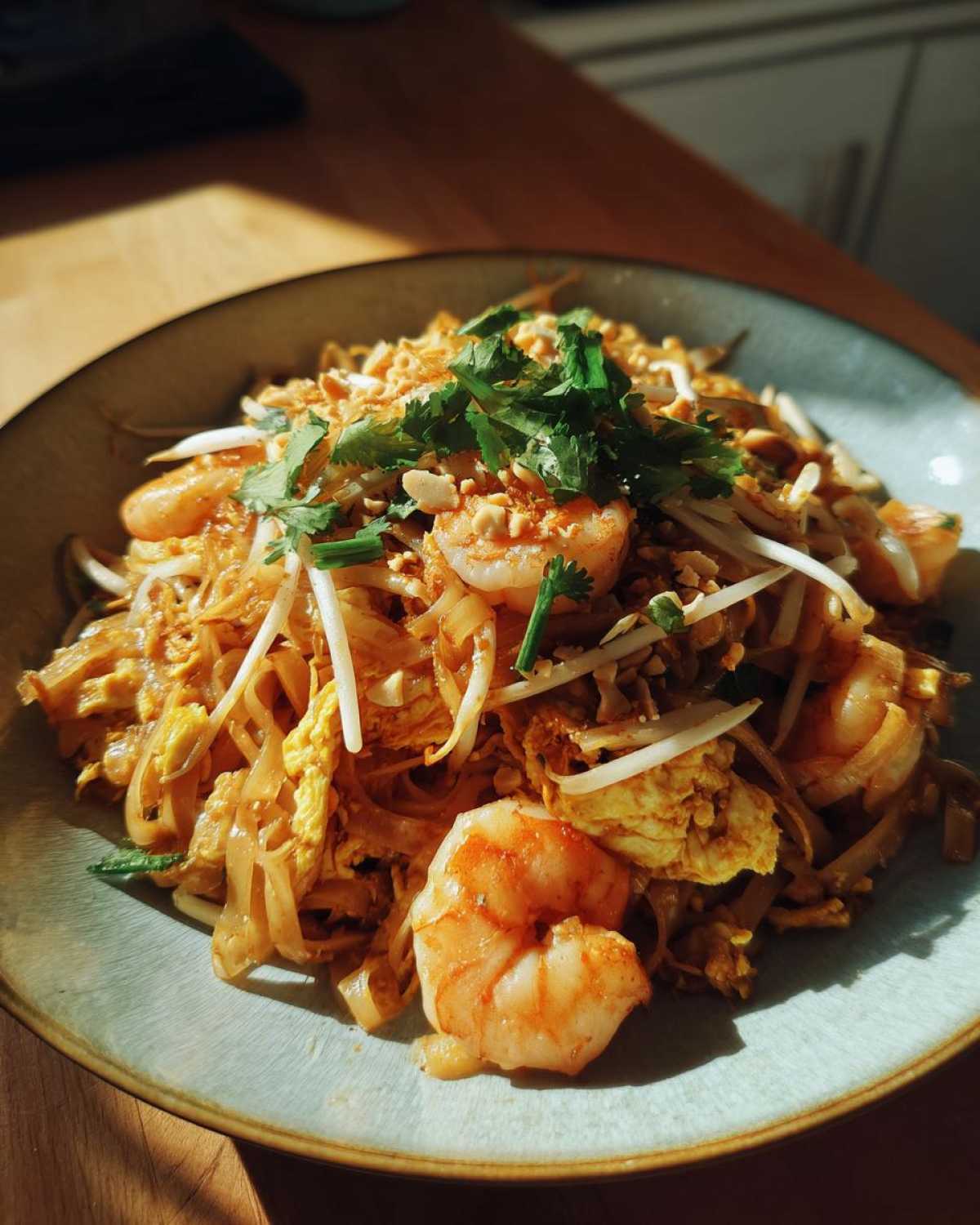 Zdjęcie Pad Thai z krewetkami, orzeszkami i kiełkami na talerzu. Tradycyjne danie kuchni tajskiej.