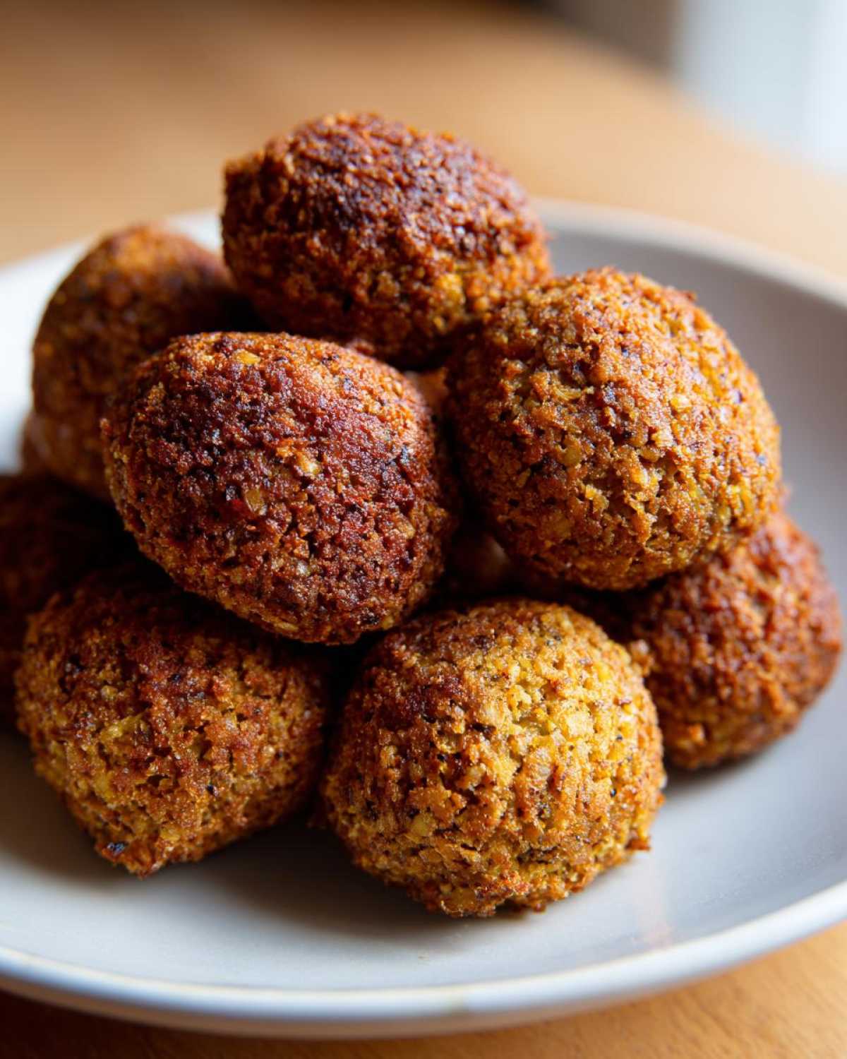 Zbliżenie na stos pysznych kulek falafel pieczony na talerzu.