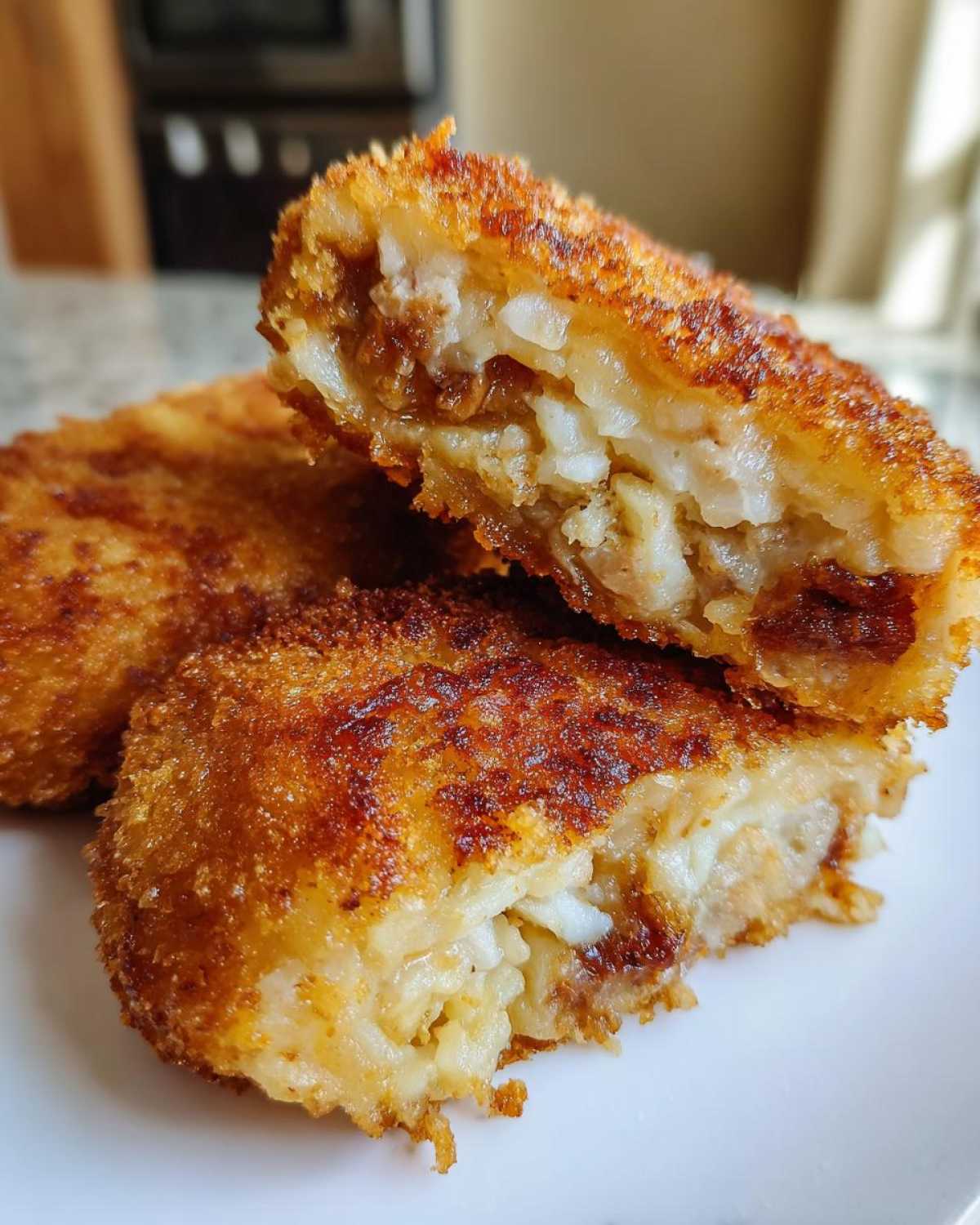 Przekrój przez kotlet ziemniaczany z kurczakiem, pokazujący chrupiącą panierkę i wilgotne nadzienie.