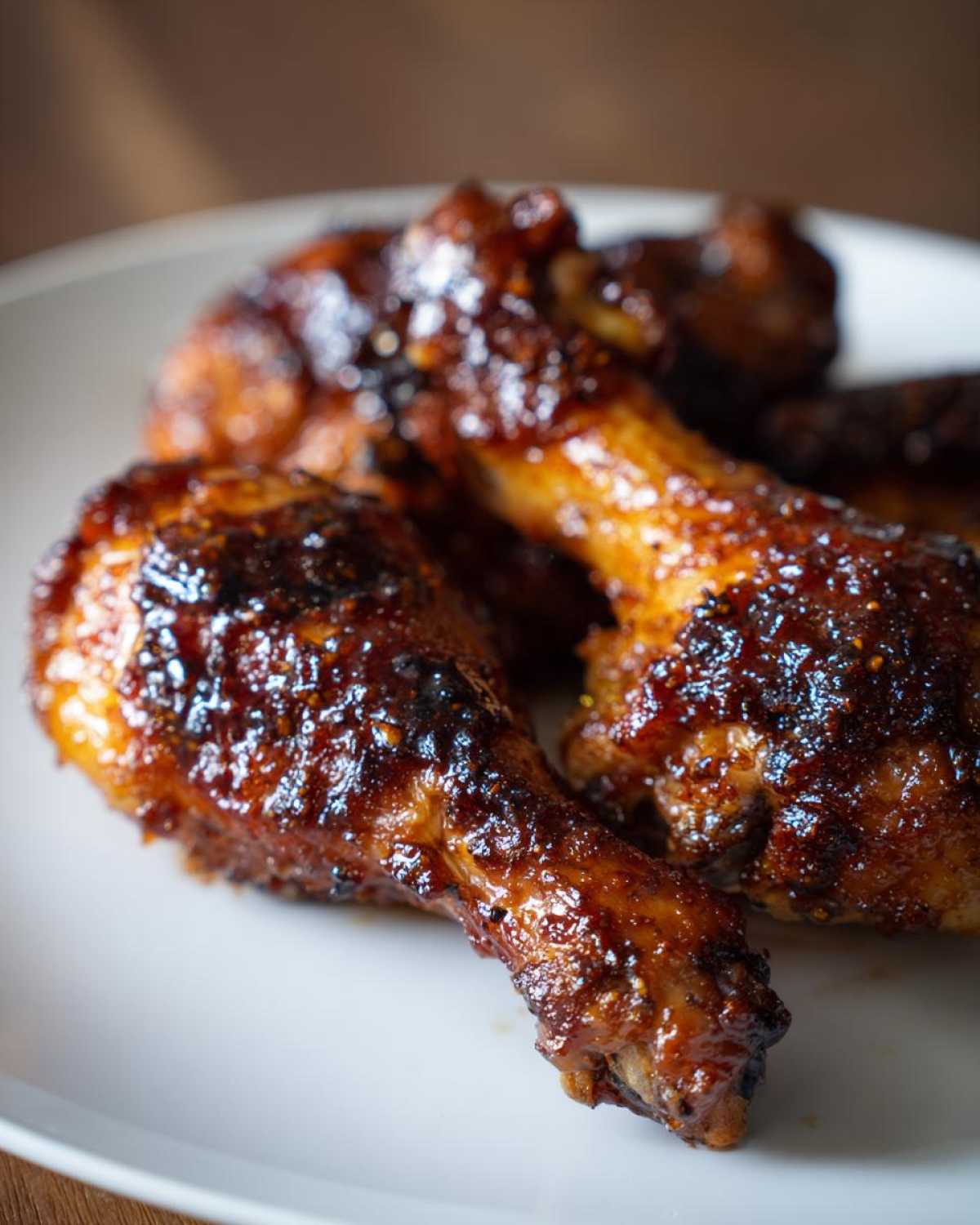 Zbliżenie na apetyczne udka z kurczaka w miodzie, polane błyszczącym, karmelizowanym sosem.